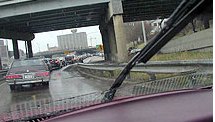 Through a car windshield. Rain & traffic.  Leaving Chicago - Kennedy Expressway at 5PM and it is raining.