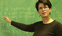 Valerie writing on a blackboard